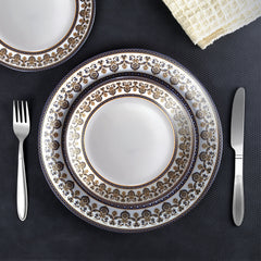 Opulent 27-piece dinner set for 6: plates, bowls, and serveware adorned with intricate Indian motifs, a blend of tradition and elegance.