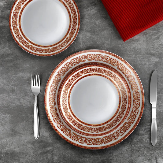 Opulent 27-piece dinner set for 6: plates, bowls, and serveware adorned with intricate Indian motifs, a blend of tradition and elegance.